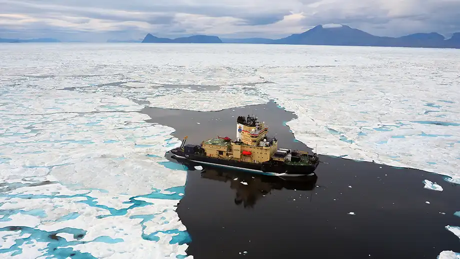 A yellow icebreaker in icy waters